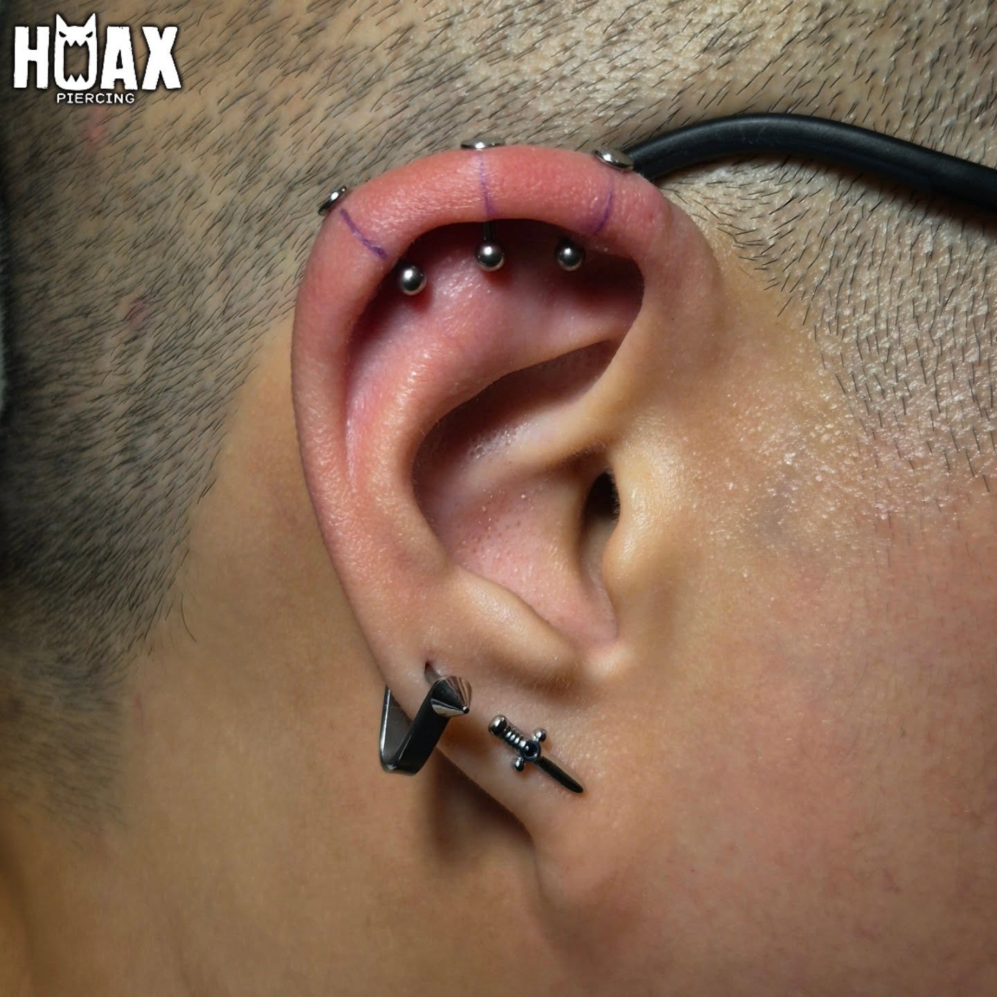 Precision ear piercing with jewelled studs and hoop