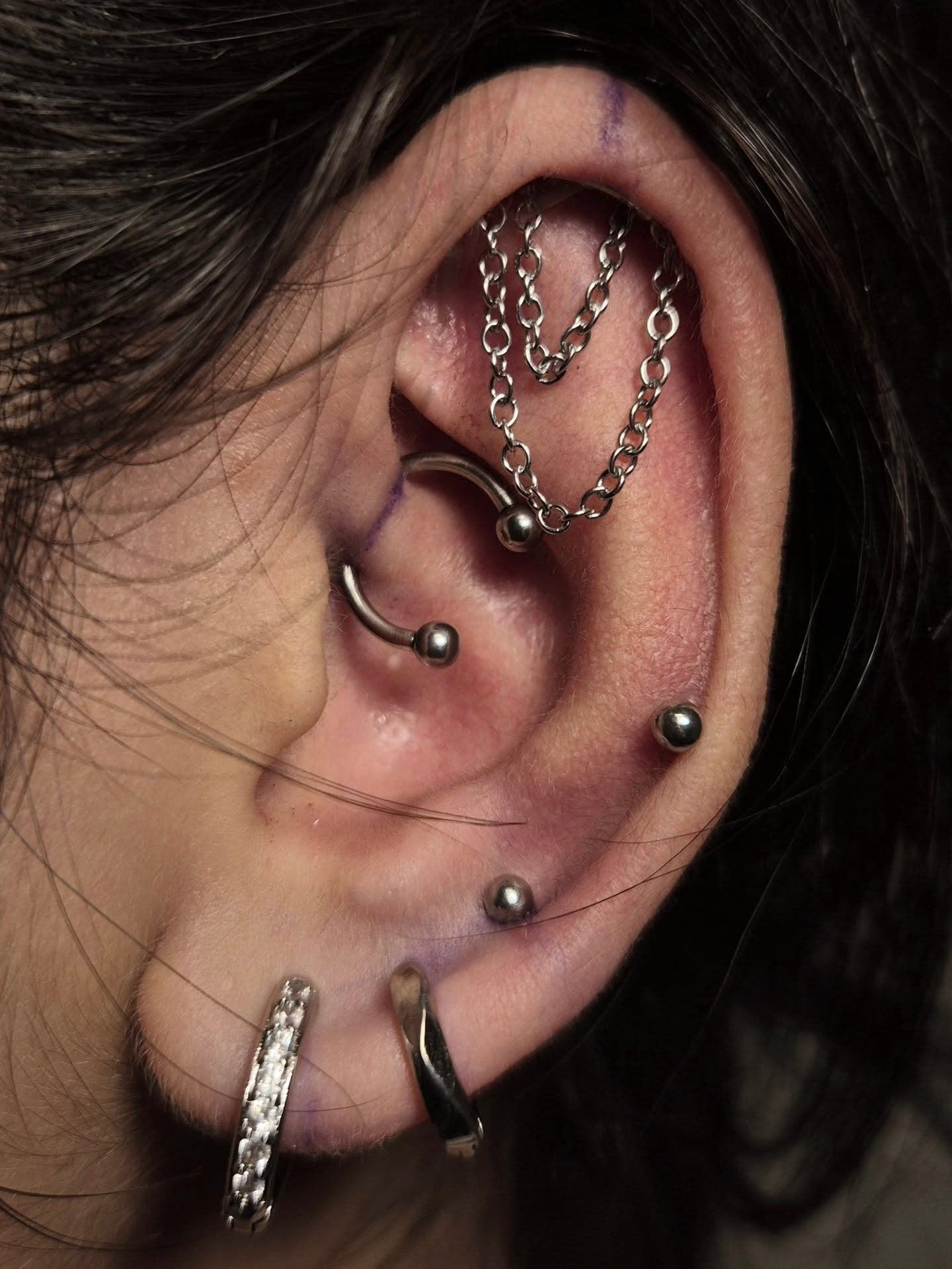 Elaborate chain jewelry with multiple ear piercings