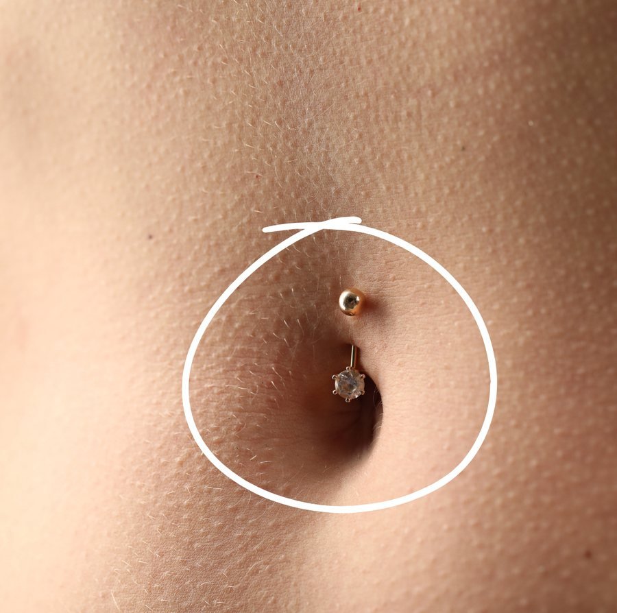 Belly button piercing with a crystal drop